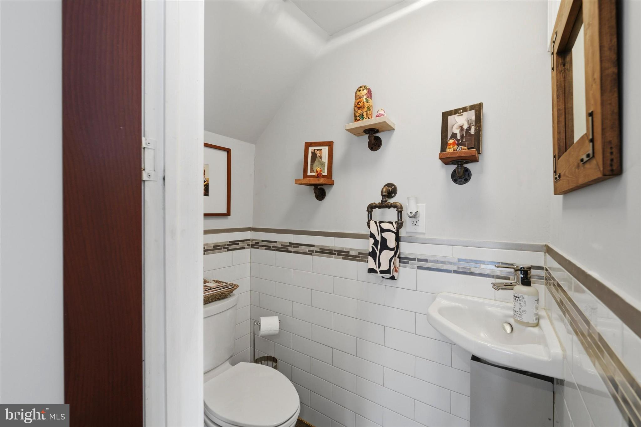 2152 East Letterly Street Philadelphia, PA 19125 - Photo 7 of 24 a bathroom with a sink toilet and a mirror