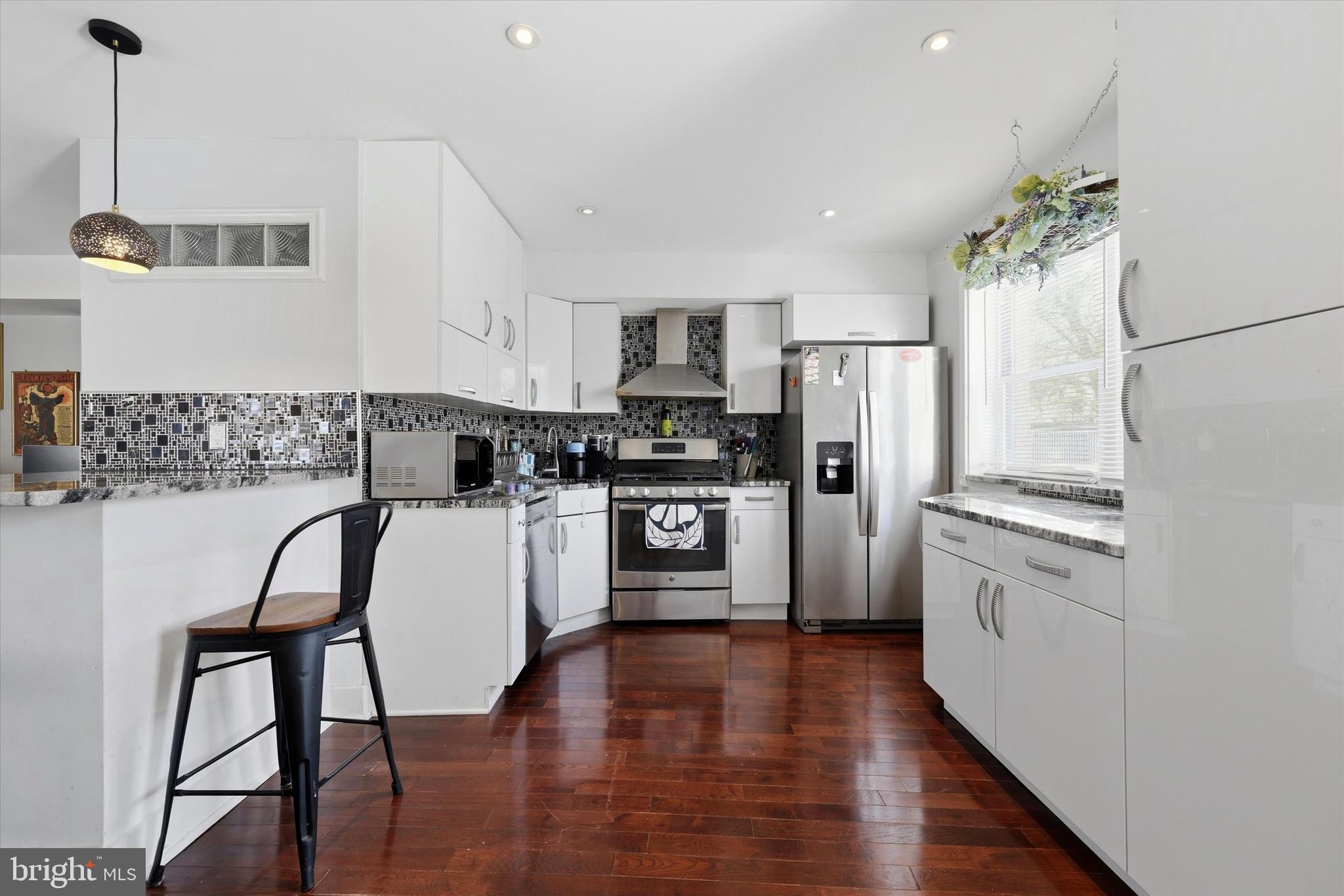 2152 East Letterly Street Philadelphia, PA 19125 - Photo 10 of 24 a kitchen with stainless steel appliances a refrigerator a stove a sink dishwasher and a refrigerator with wooden floor
