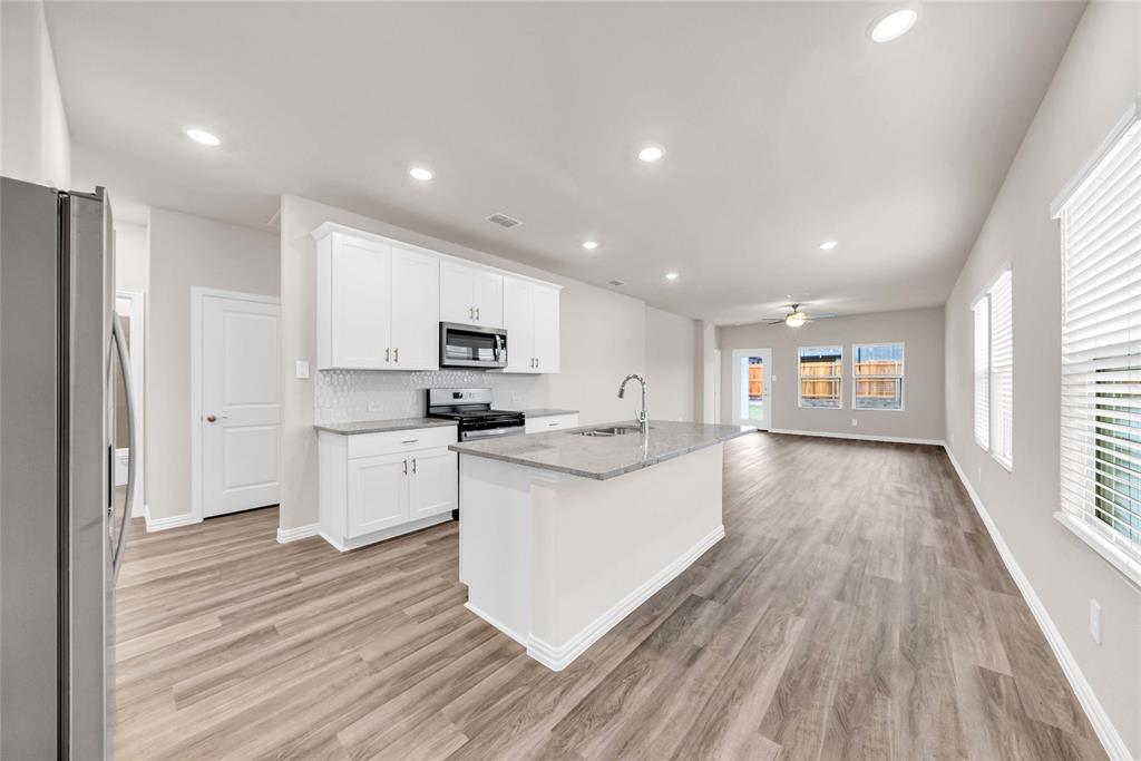 417 Martell Road Lowry Crossing, TX 75069 - Photo 6 of 29 a kitchen with stainless steel appliances a refrigerator sink and cabinets