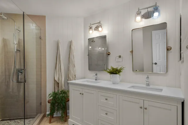 a bathroom with a double vanity sink and a mirror