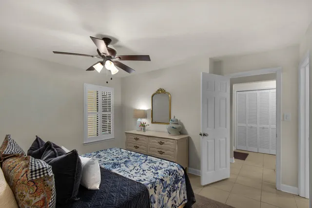 a bedroom with a bed dresser and a window