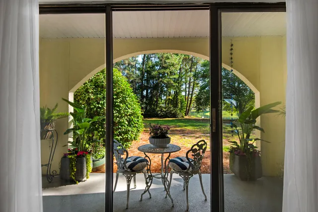 a dining room view with a garden view