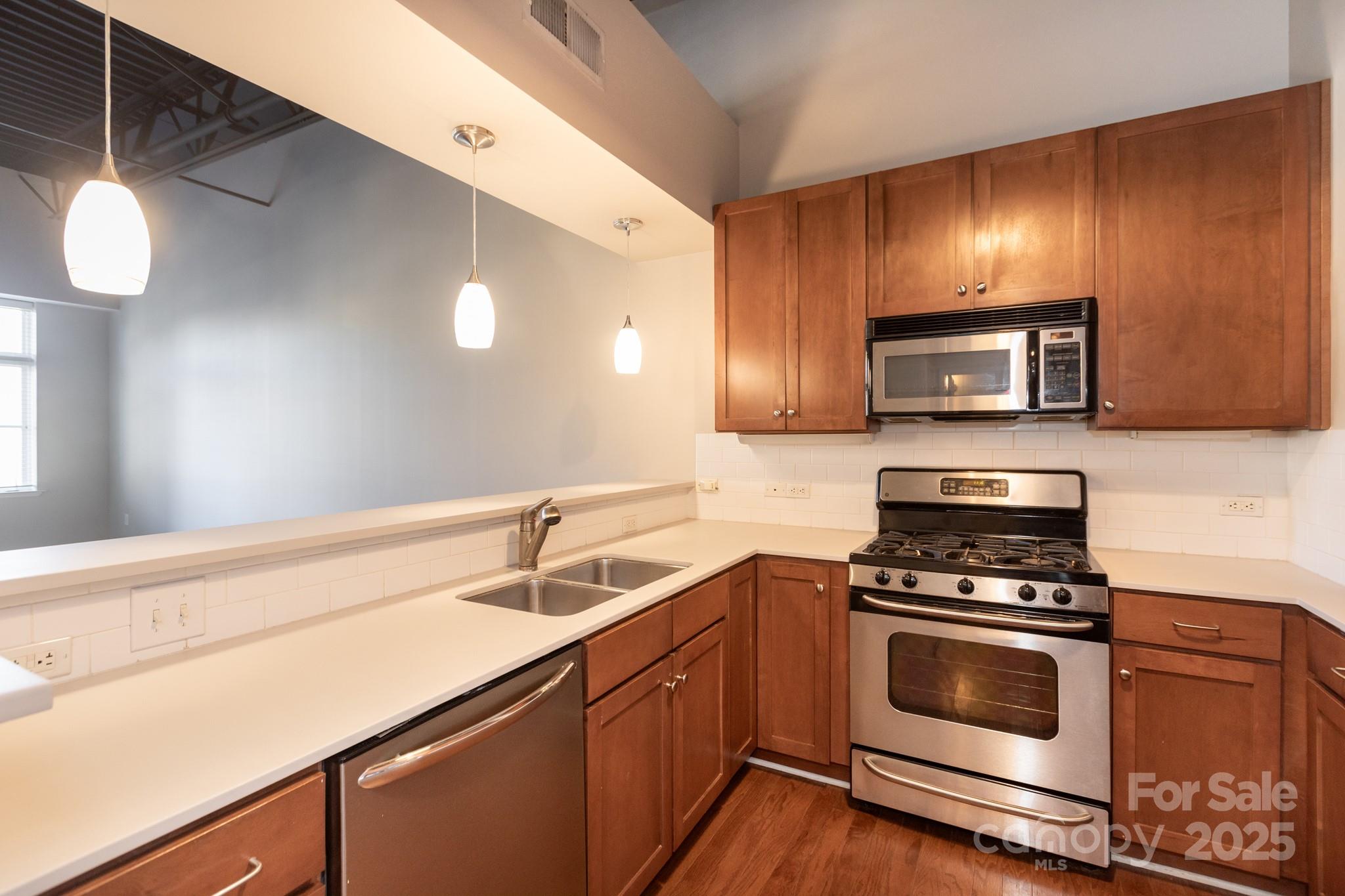 3920 Sharon Road Charlotte, NC 28211 - Photo 11 of 38 a kitchen with sink a microwave and cabinets