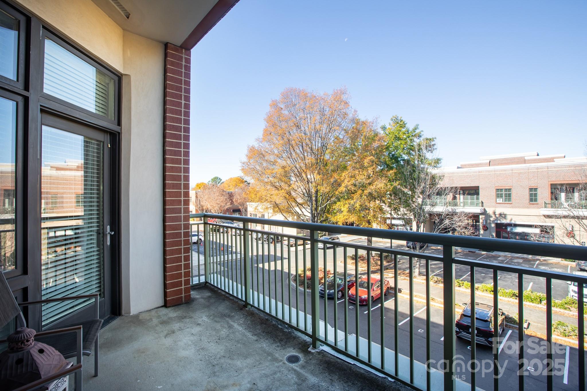 3920 Sharon Road Charlotte, NC 28211 - Photo 21 of 38 a view of a porch with a floor to ceiling window next to a yard