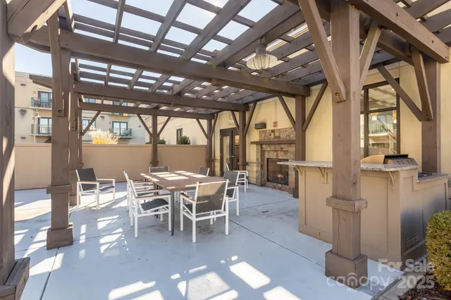 a dining room with furniture floor to ceiling windows and plants
