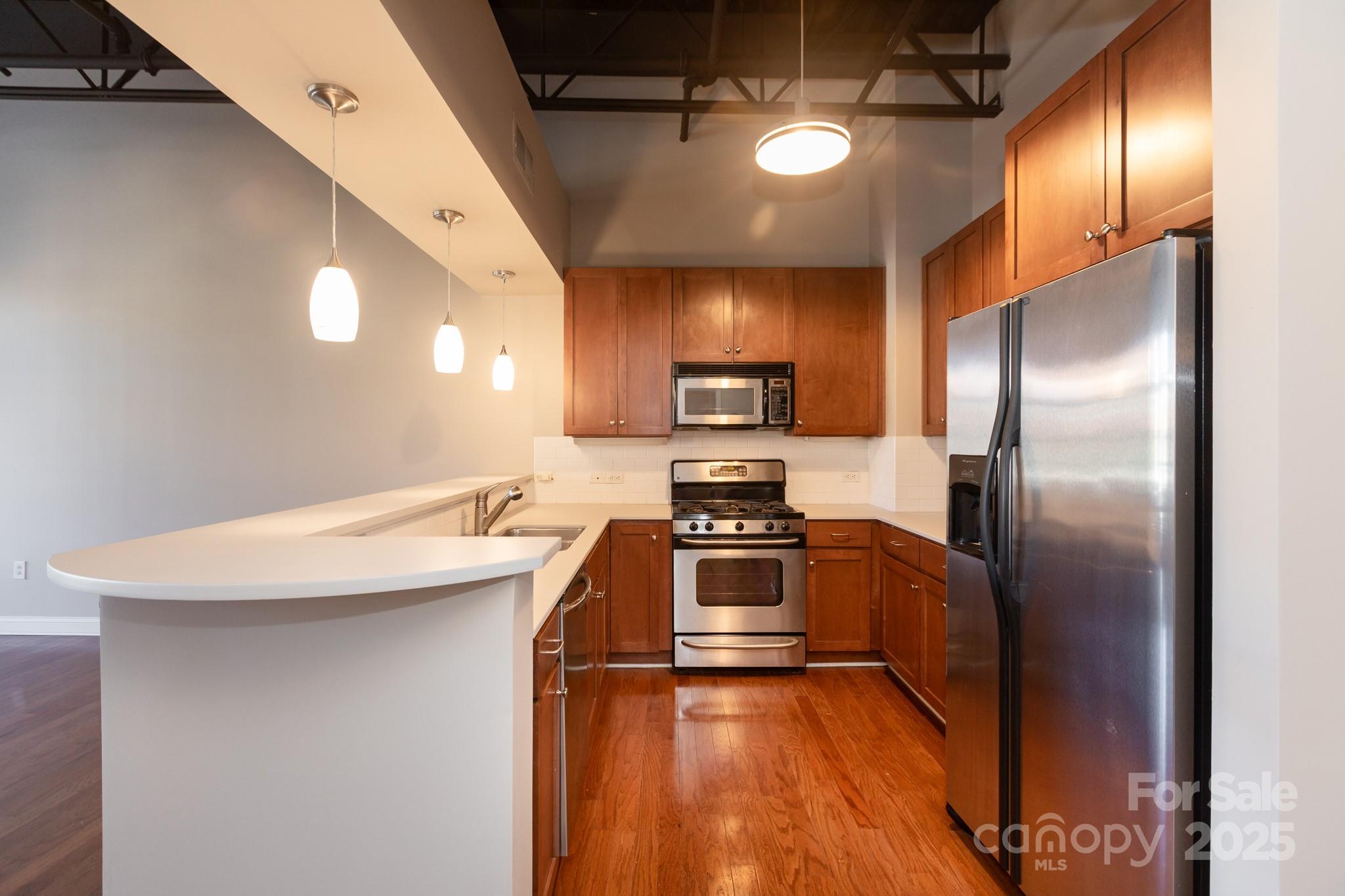 3920 Sharon Road Charlotte, NC 28211 - Photo 9 of 38 a kitchen with stainless steel appliances a sink stove refrigerator and microwave
