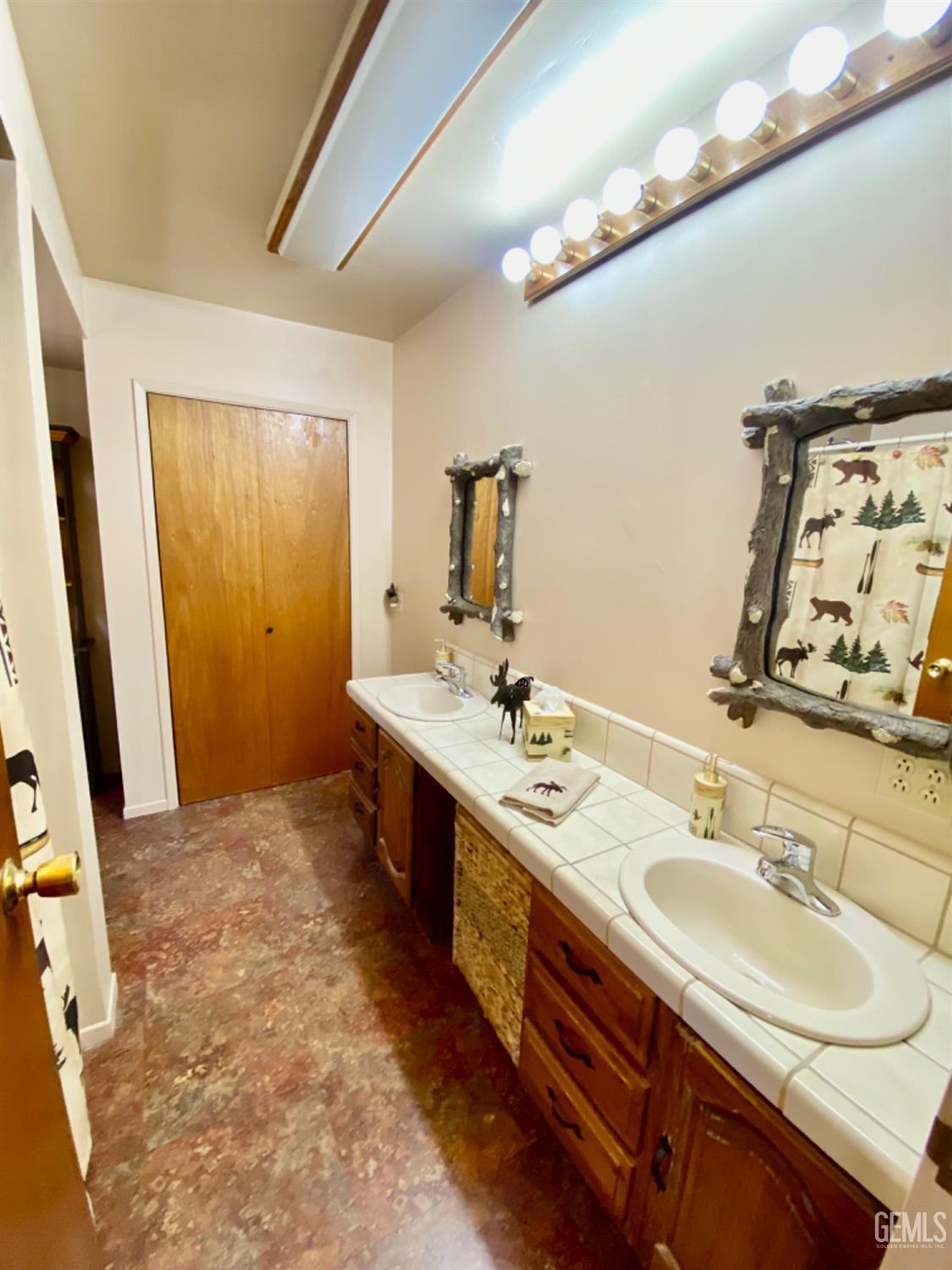 Undisclosed Address Posey, CA 93260 - Photo 12 of 35 a bathroom with a double vanity sink and a mirror