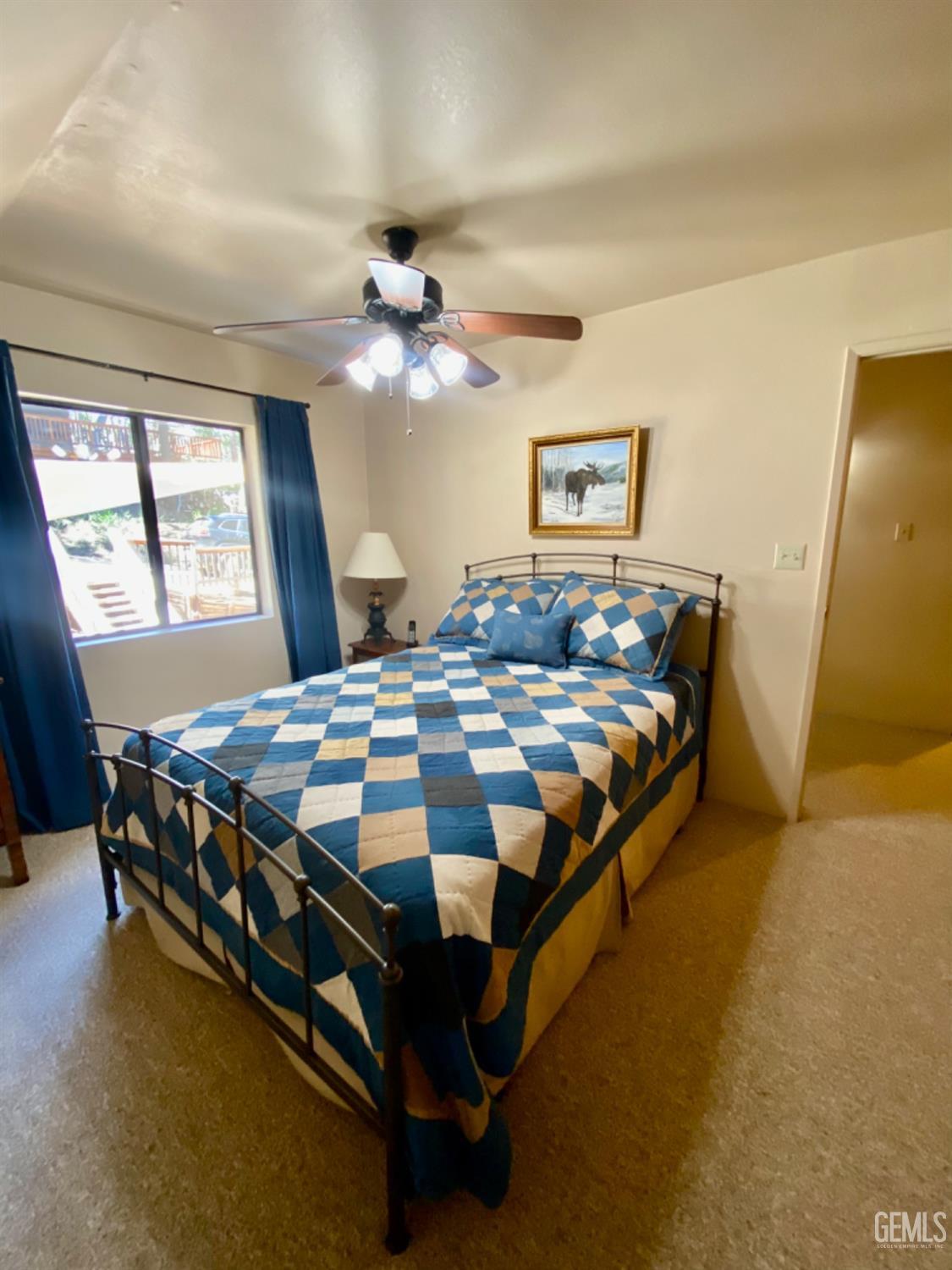 Undisclosed Address Posey, CA 93260 - Photo 18 of 35 a bedroom with a bed and a chandelier