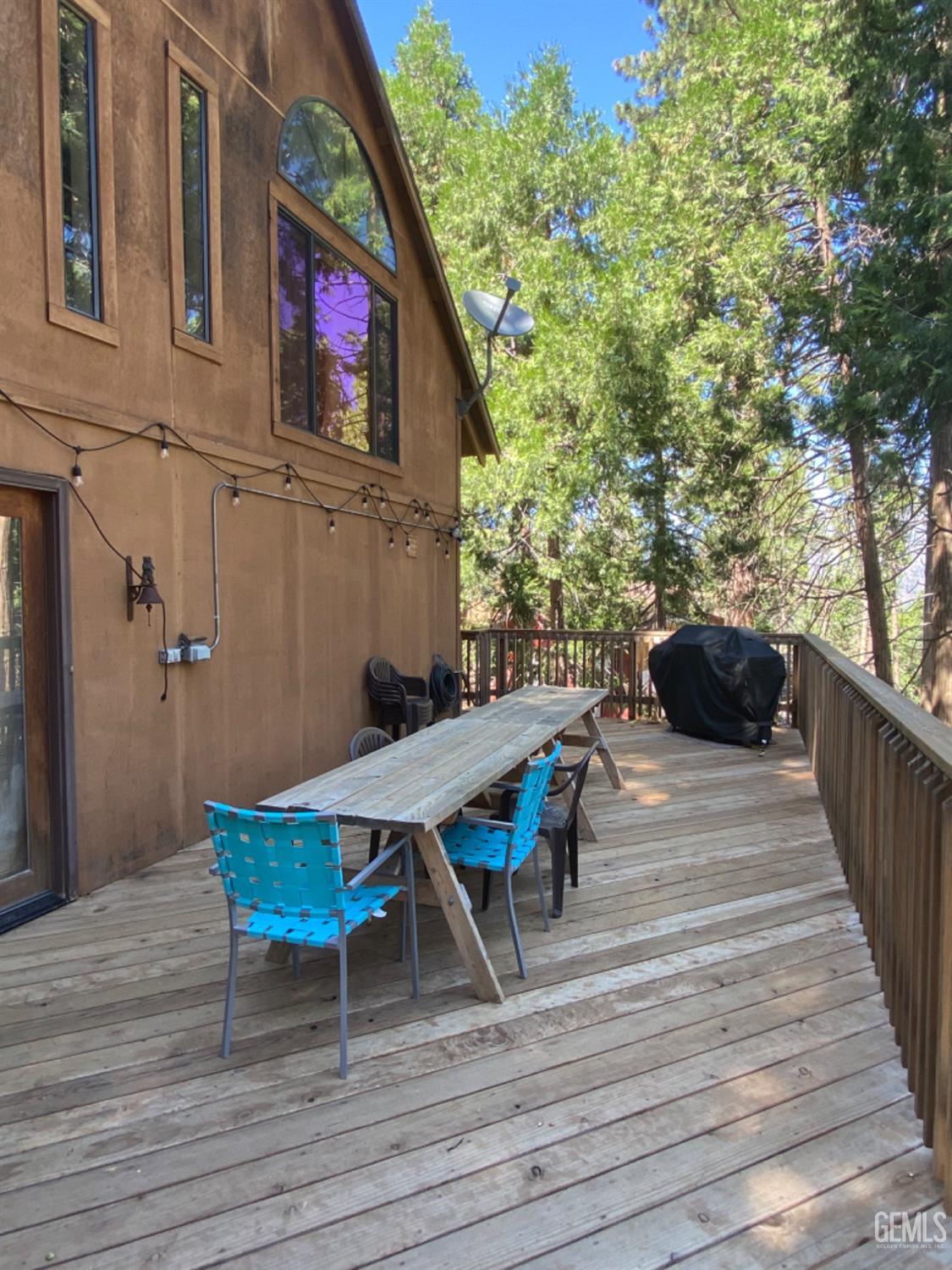 Undisclosed Address Posey, CA 93260 - Photo 31 of 35 a view of a deck with table and chairs with wooden floor and fence