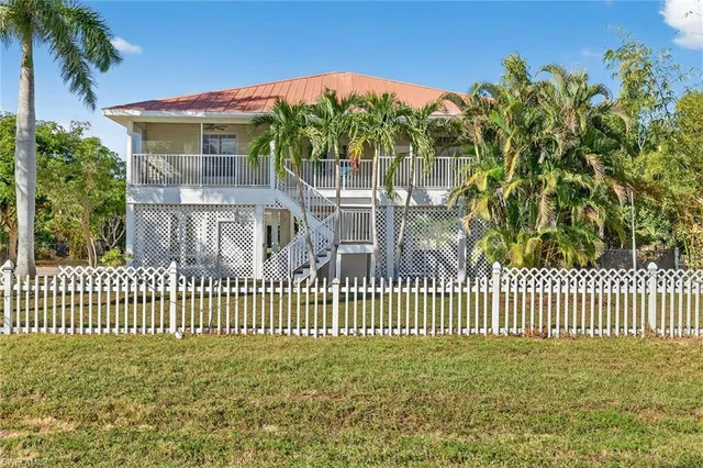 a view of a house with a small yard and a fountain
