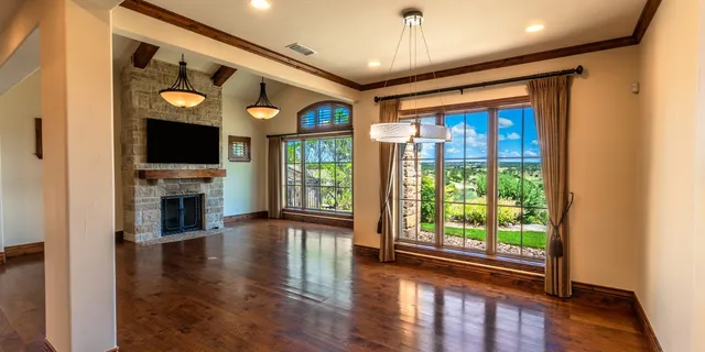 wooden floor in an empty room with a window