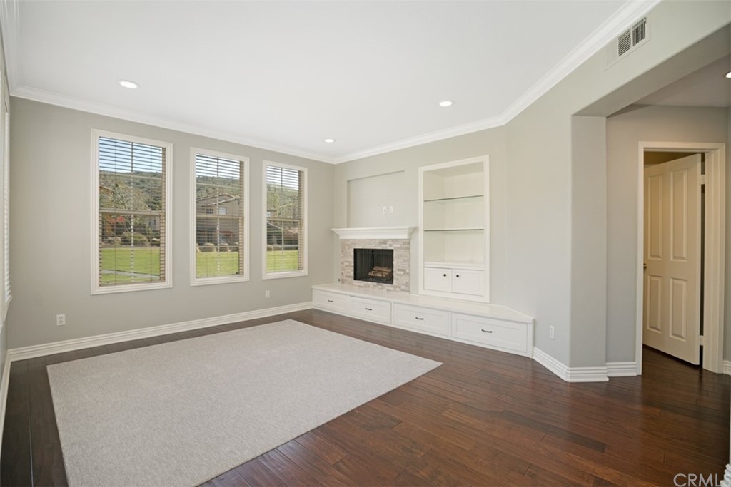 10108 Marchant Avenue Tustin, CA 92782 - Photo 2 of 15 an empty room with wooden floor and windows