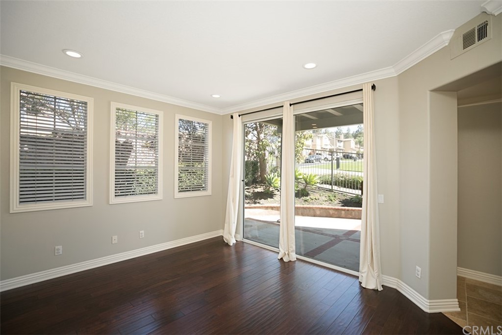 10108 Marchant Avenue Tustin, CA 92782 - Photo 8 of 15 a view of an empty room with wooden floor and a window