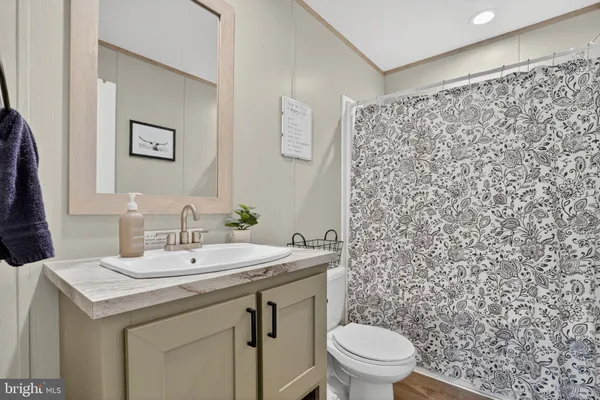 a bathroom with a sink toilet and a mirror