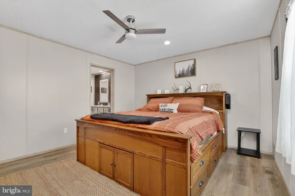 a bedroom with a bed and a night stand