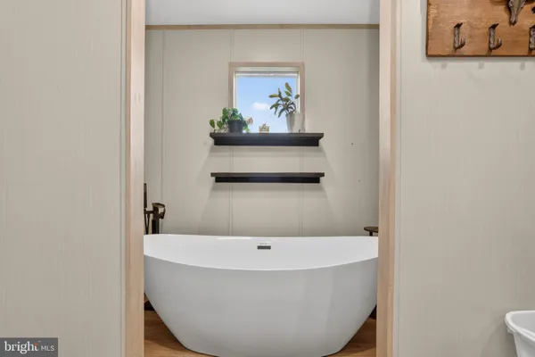 a bathroom with a tub and toilet