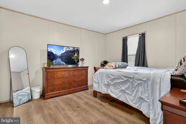 a bedroom with a bed and a dresser