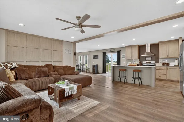 a living room with furniture and kitchen view