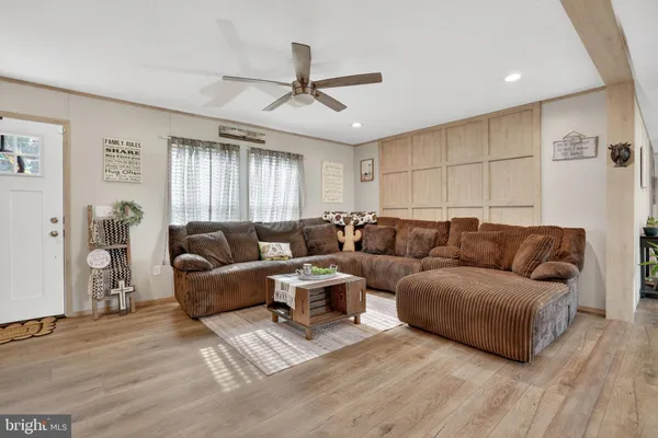 a living room with a couch and a ceiling fan