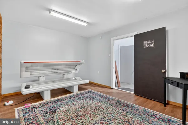 a living room with a bed and a dresser