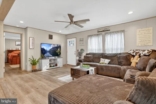 a living room with furniture a large window and a flat screen tv