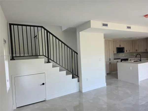 a view of a hallway with washer and dryer