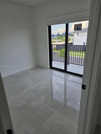 a view of a porch with wooden floor and door