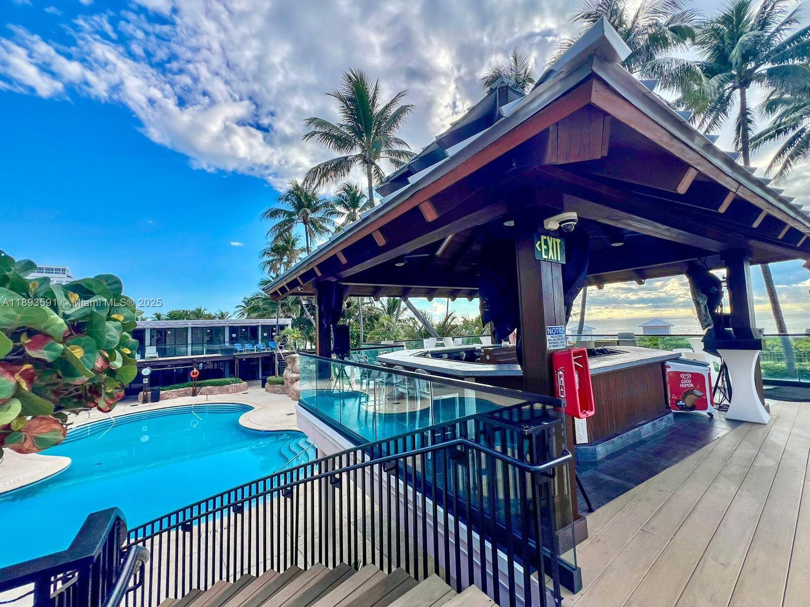 5225 Collins Avenue, Unit 517 Miami Beach, FL 33140 - Photo 17 of 20 a view of a chairs and tables in the balcony