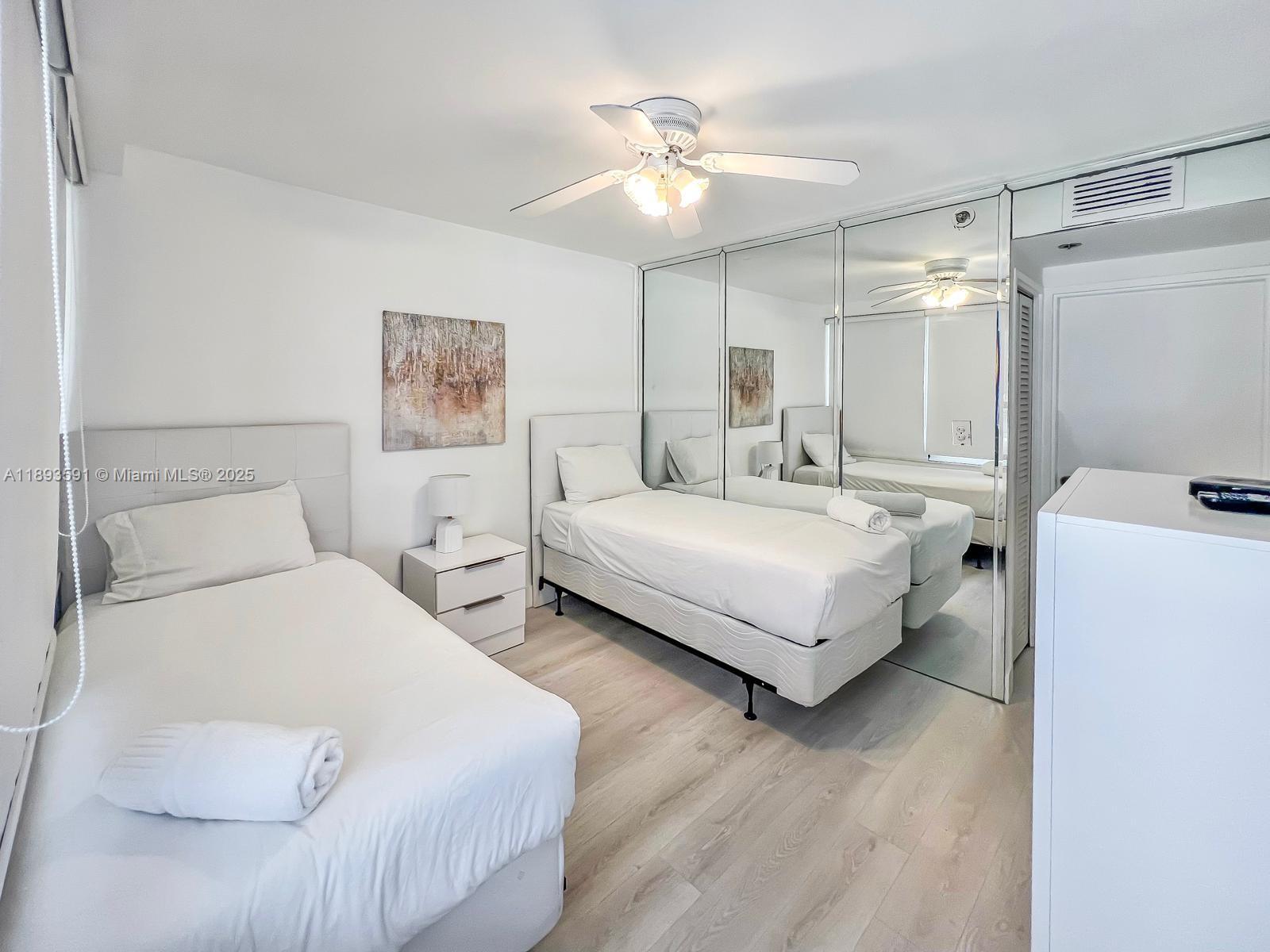 5225 Collins Avenue, Unit 517 Miami Beach, FL 33140 - Photo 5 of 20 a bedroom with a bed and a chandelier