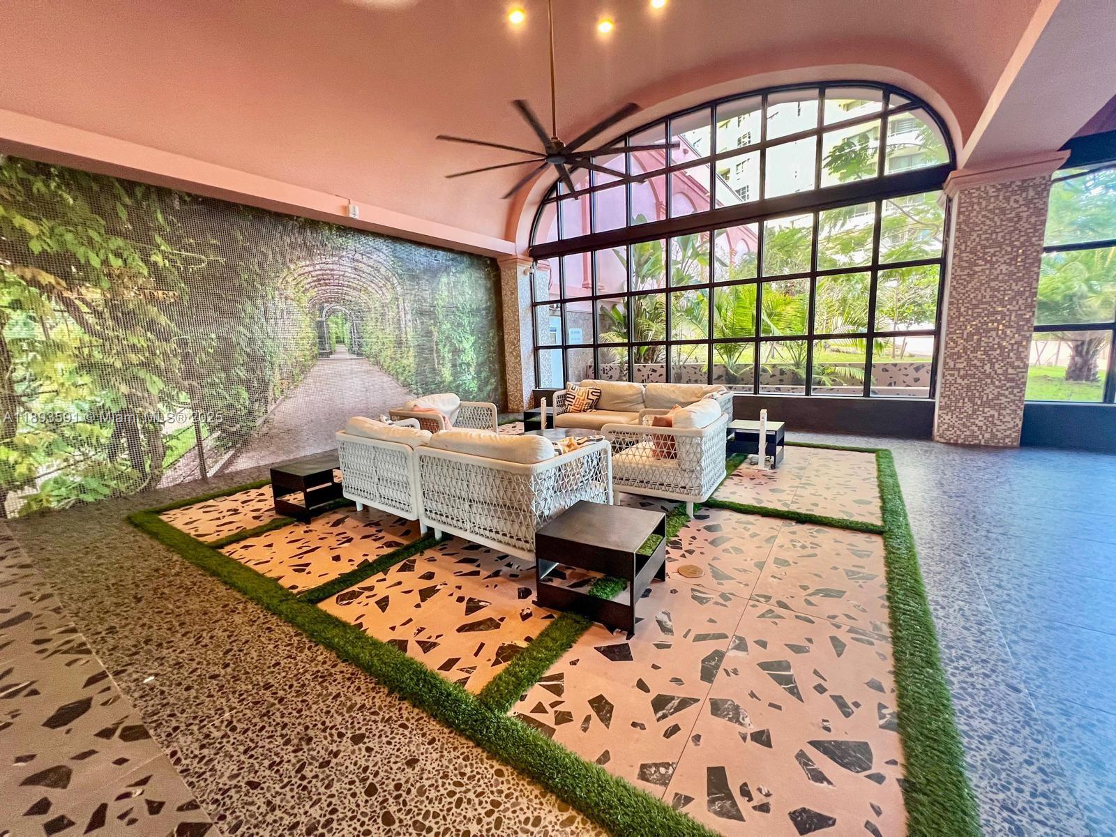 5225 Collins Avenue, Unit 517 Miami Beach, FL 33140 - Photo 8 of 20 a living room with furniture and floor to ceiling windows