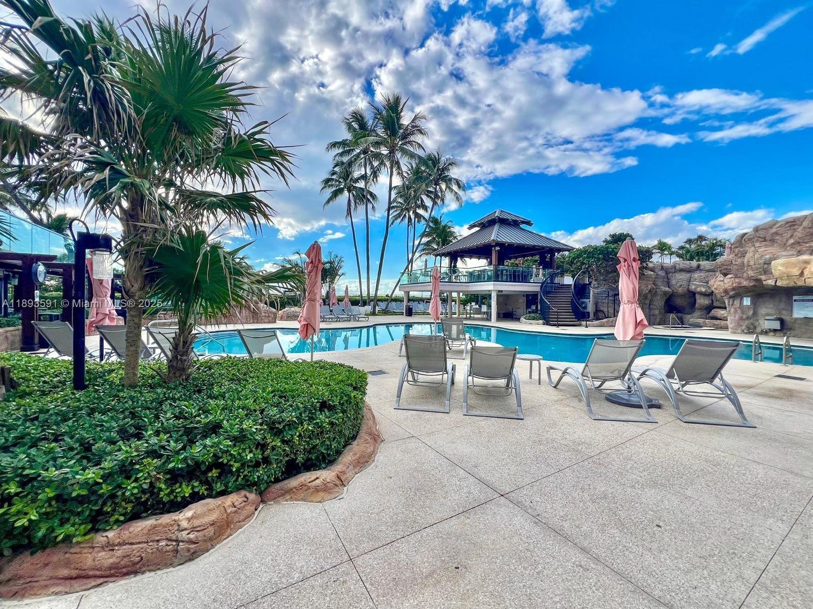 5225 Collins Avenue, Unit 517 Miami Beach, FL 33140 - Photo 10 of 20 a view of a patio with swimming pool and furniture