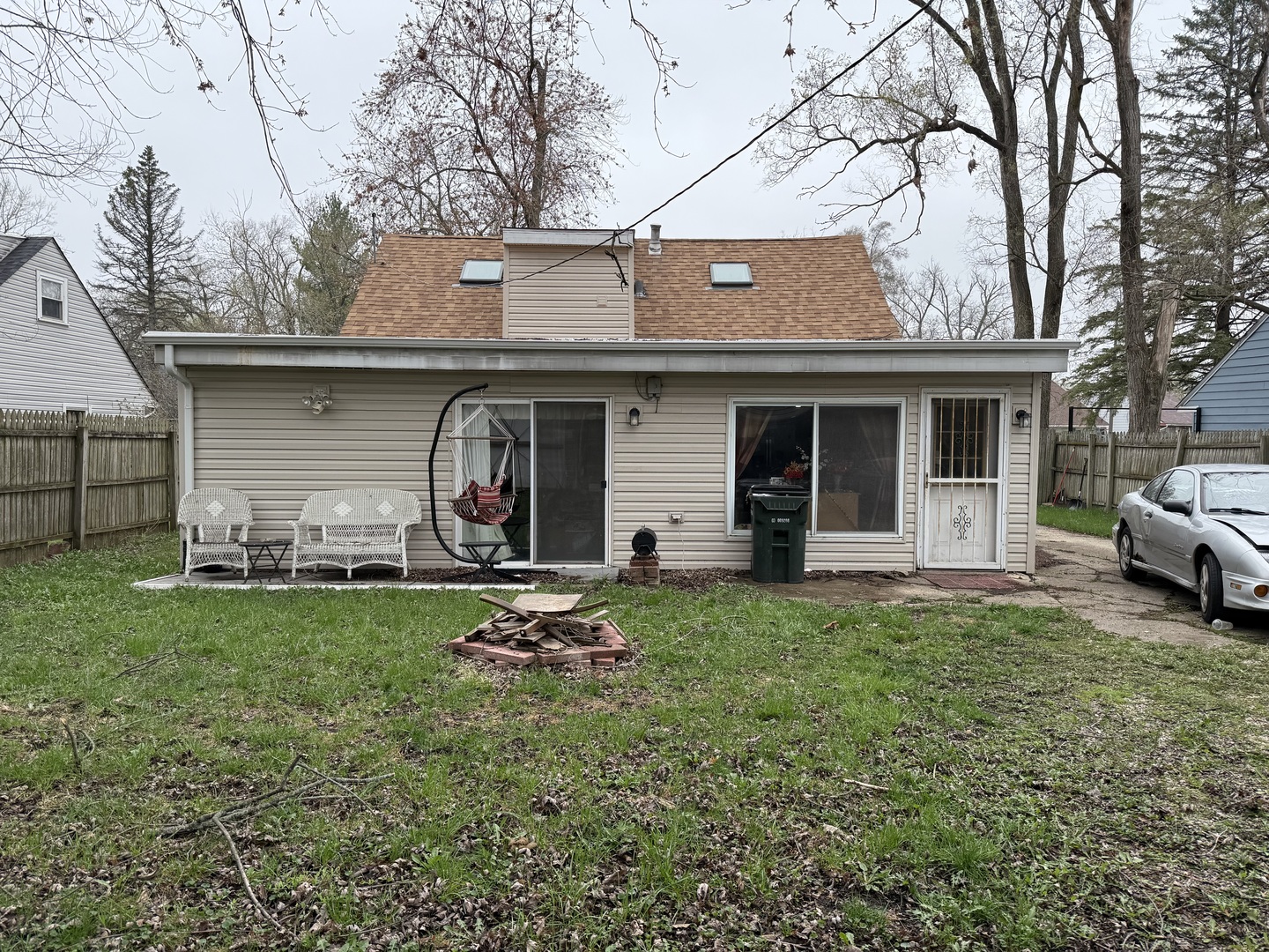 54 Apache Street Park Forest, IL 60466 - Photo 20 of 21 a backyard of a house with table and chairs and large tree