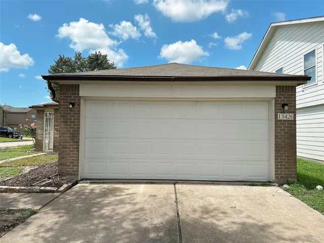 a view of a wooden door and a yard