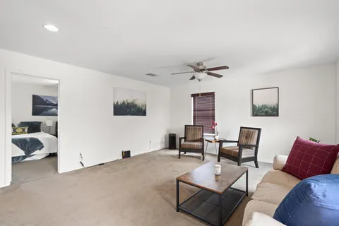 a living room with furniture and white walls