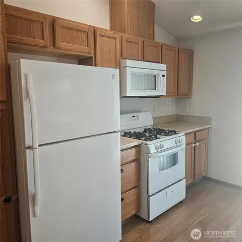 a white refrigerator freezer sitting inside of a kitchen