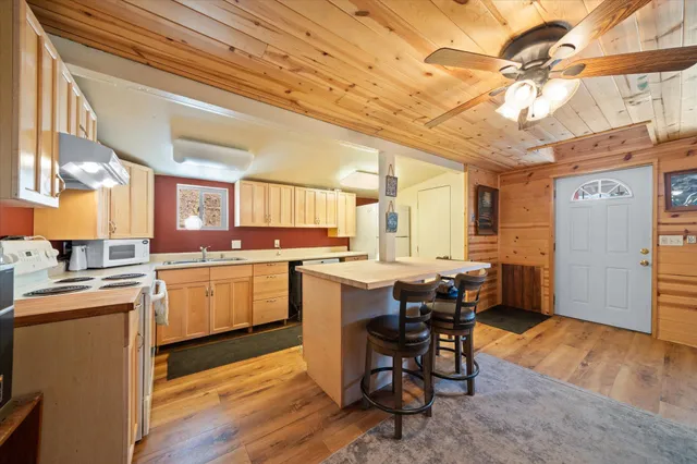 a kitchen with a table chairs refrigerator and cabinets