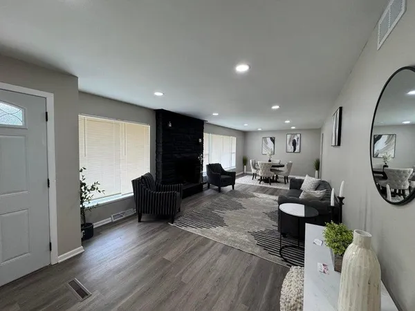a living room with furniture a rug and a fireplace