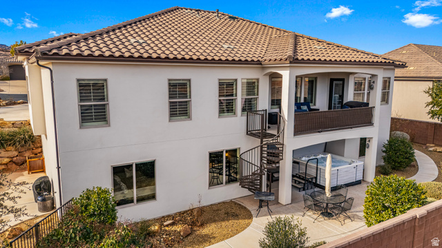 2311 South 1340 West St. George, UT 84770 - Photo 47 of 56 Back of property with a tile roof, a fenced backyard, stucco siding, a hot tub, and a patio area