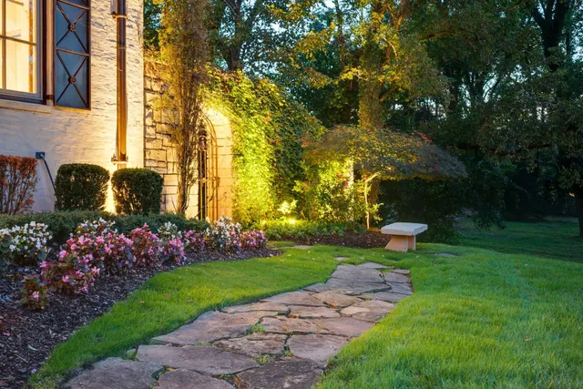 a open kitchen with stainless steel appliances granite countertop a stove a refrigerator a kitchen island a dining table and chairs