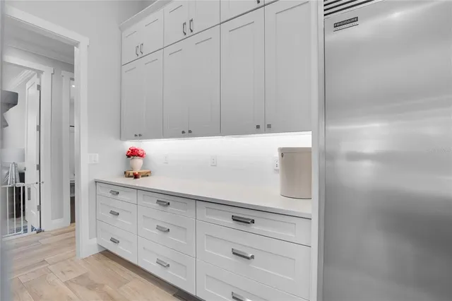 a kitchen with stainless steel appliances granite countertop a refrigerator and a stove top oven