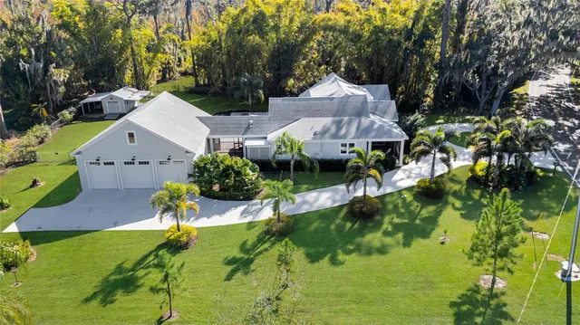 a view of a patio with table and chairs and potted plants