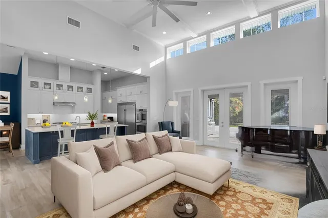 a view of living room kitchen with furniture and wooden floor