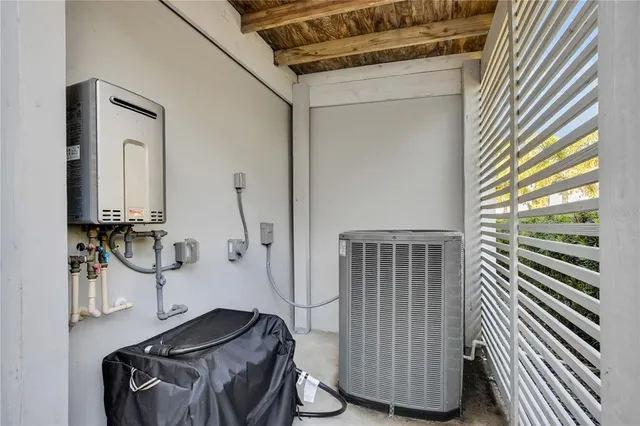 a view of a hallway with a window and wooden floor