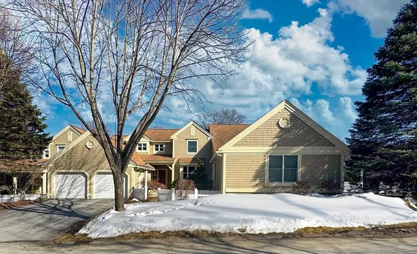 a view of a house with a yard covered in snow