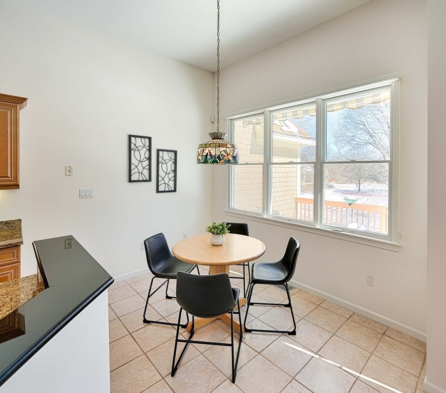 173 Nobscot Road, Unit 173 Sudbury, MA 01776 - Photo 13 of 37 a view of a dining room with furniture and window