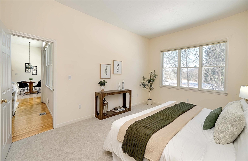173 Nobscot Road, Unit 173 Sudbury, MA 01776 - Photo 15 of 37 a bedroom with a bed and a large mirror