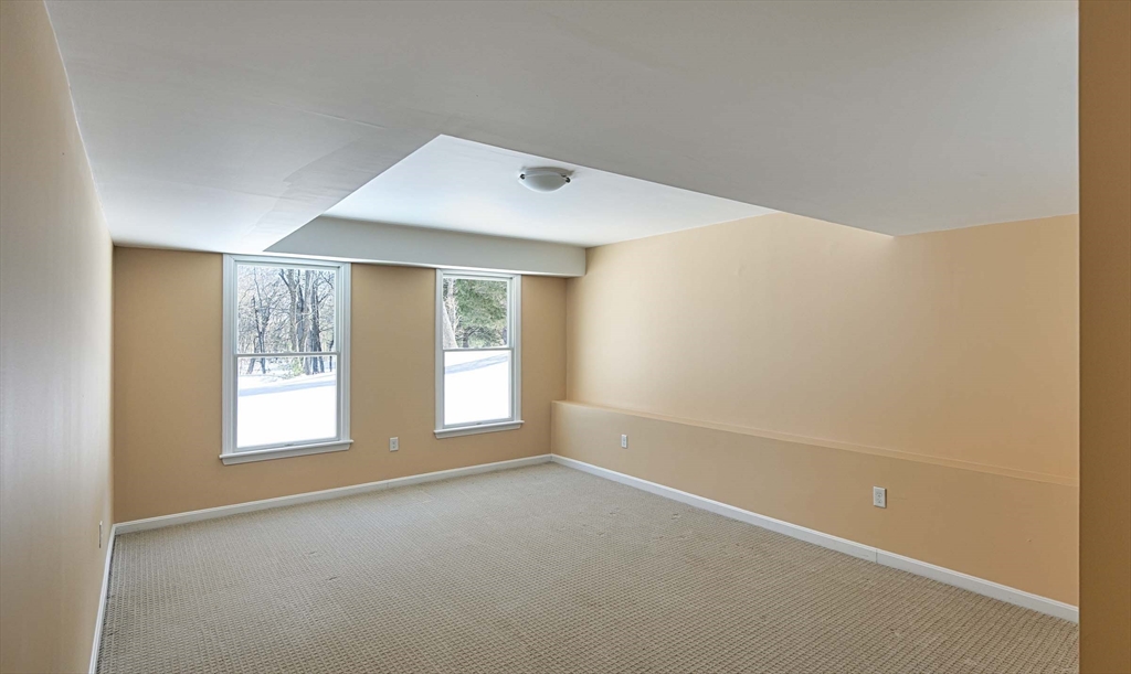173 Nobscot Road, Unit 173 Sudbury, MA 01776 - Photo 27 of 37 a view of an empty room with a window