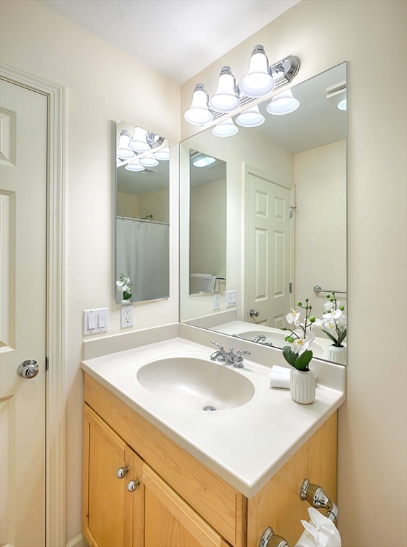 173 Nobscot Road, Unit 173 Sudbury, MA 01776 - Photo 28 of 37 a bathroom with a sink and a mirror