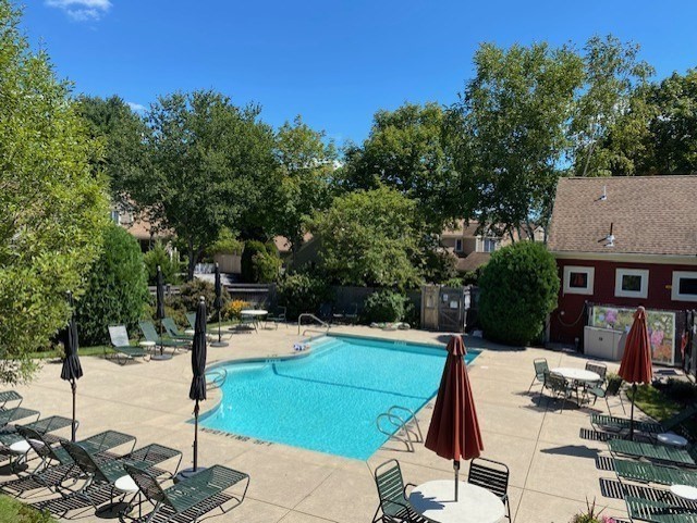 173 Nobscot Road, Unit 173 Sudbury, MA 01776 - Photo 32 of 37 a view of a patio with table and chairs with wooden floor and fence