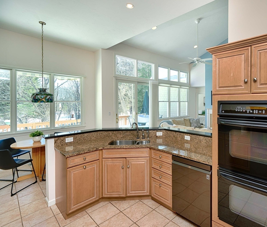 173 Nobscot Road, Unit 173 Sudbury, MA 01776 - Photo 9 of 37 a kitchen that has a sink stove and cabinets